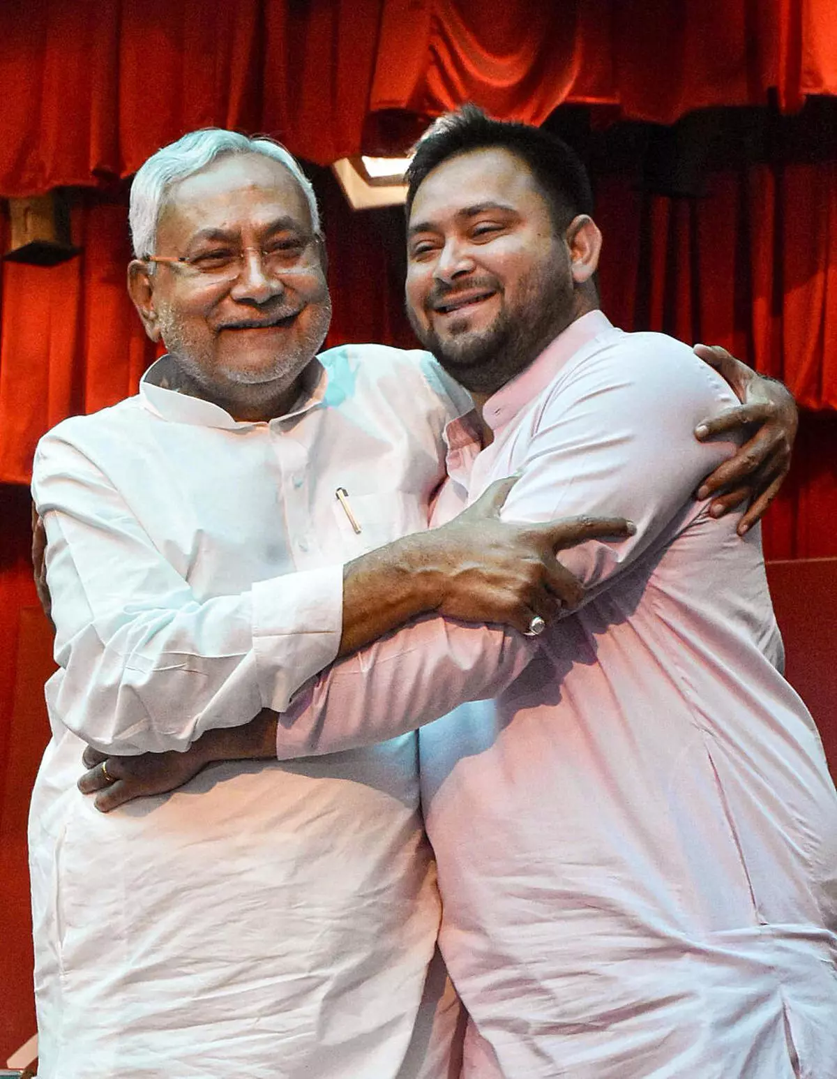 Bihar Chief Minister Nitish Kumar being greeted by Deputy Chief Minister Tejashwi Yadav after taking oath, at Raj Bhavan in Patna, Wednesday, August 10, 2022. (PTI)