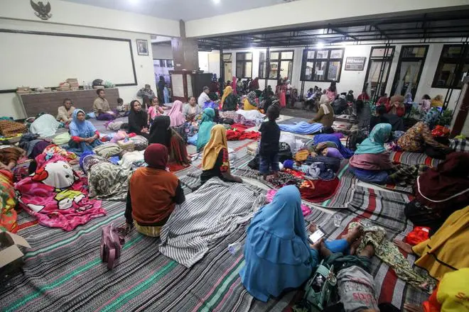 Villagers rest as they shelter at a district office after being evacuated following the eruption of Mount Semeru volcano in Lumajang, East Java province, Indonesia, December 4, 2022. REUTERS Villagers rest as they shelter at a district office after being evacuated following the eruption of Mount Semeru volcano in Lumajang, East Java province, Indonesia, December 4, 2022. REUTERS