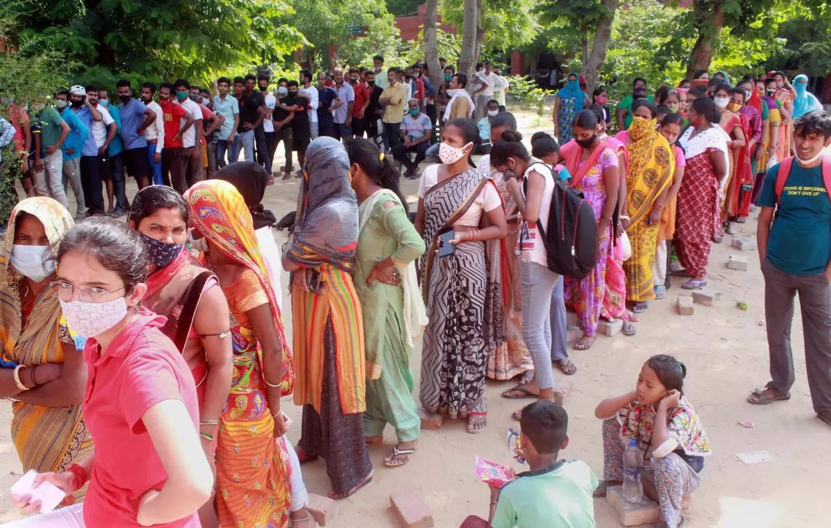 Beneficiaries wait in queues to receive Covid-19 vaccine dose, at a government school-turned vaccination centre at Shivaji Nagar in Gurugram. (PTI/File photo)