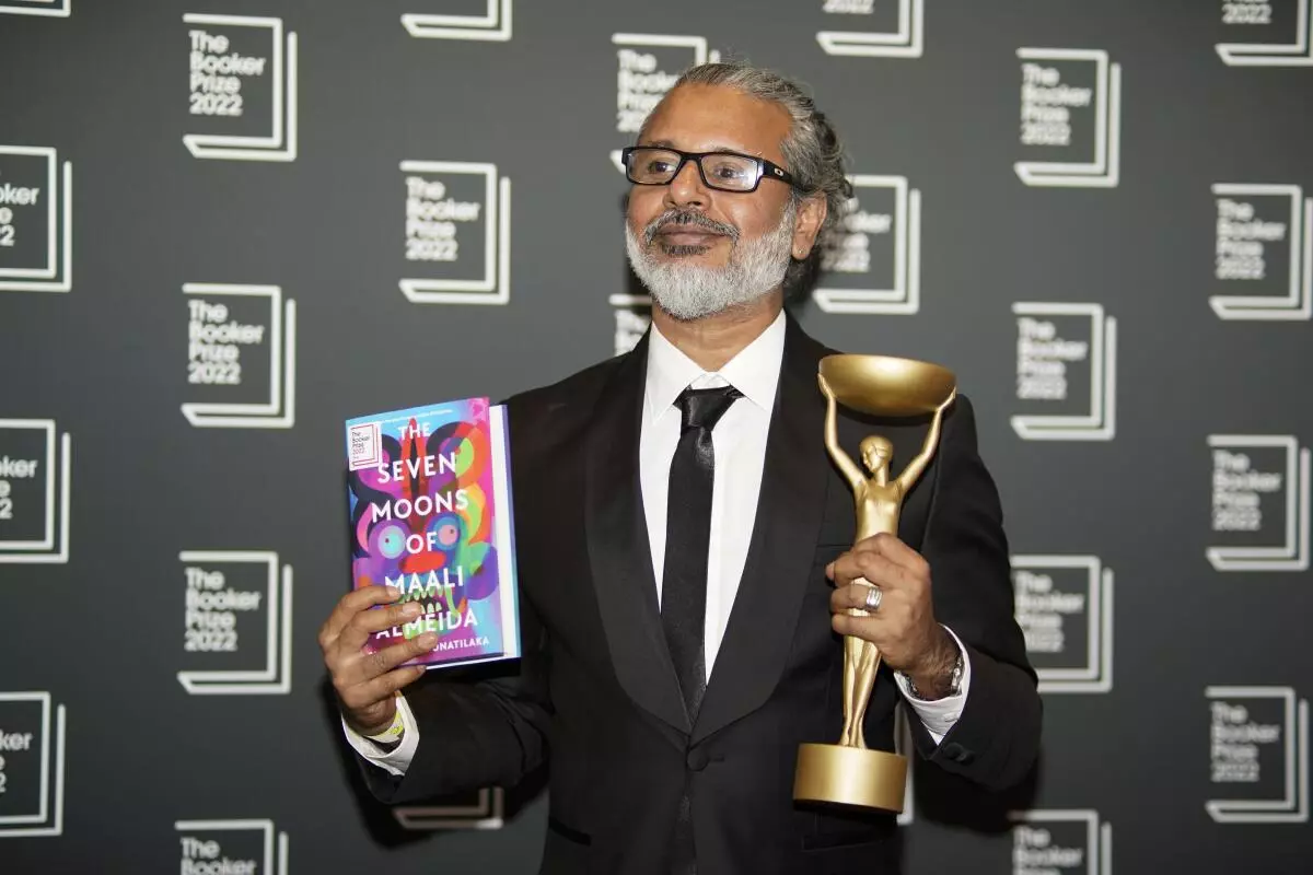 Author Shehan Karunatilaka holds the Booker Prize during a photo call after the announcement of his victory, at the Roundhouse, in London, Monday, October 17, 2022. (AP/PTI Photo)