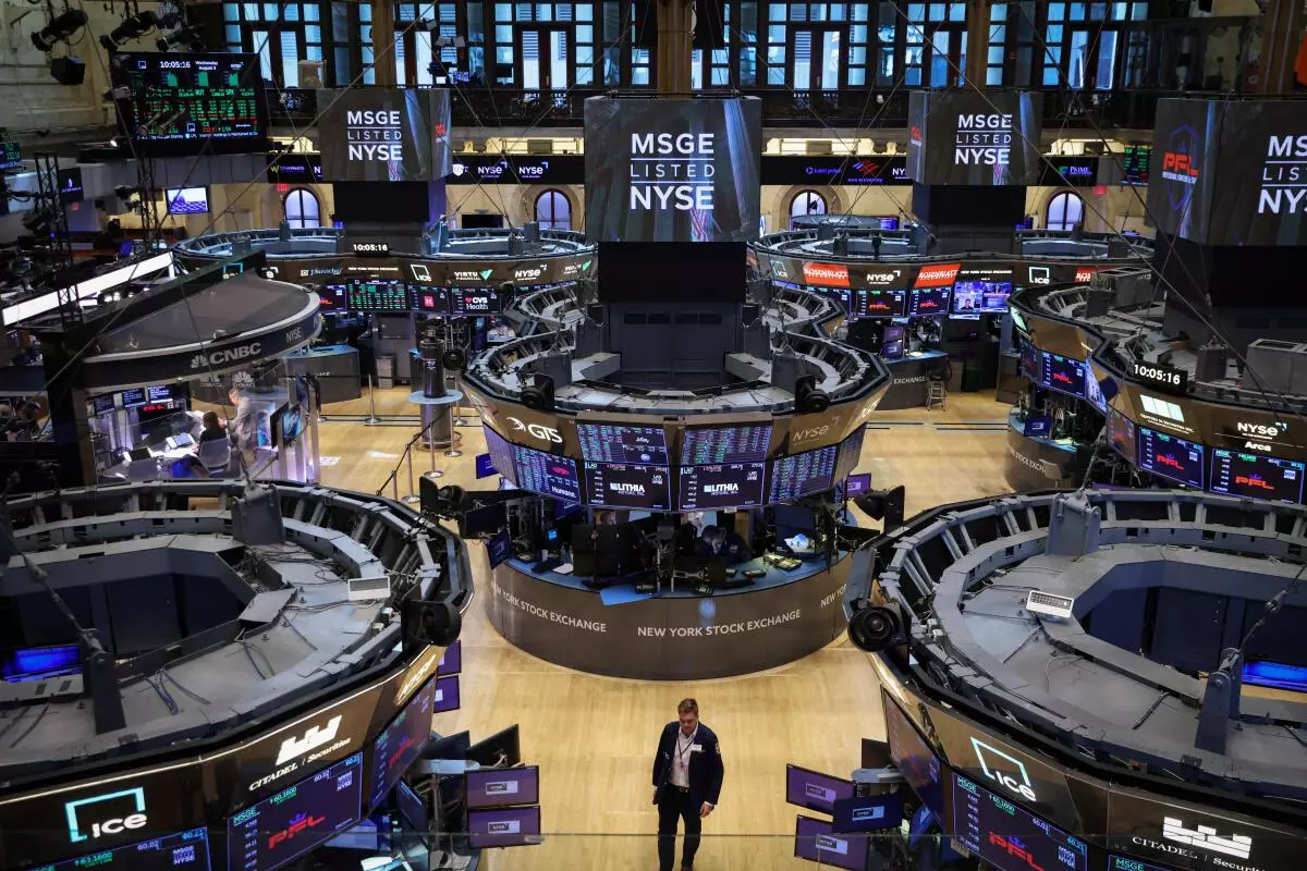 A trader walks on the trading floor at the New York Stock Exchange (NYSE) in Manhattan, New York City, US, August 3, 2022. REUTERS