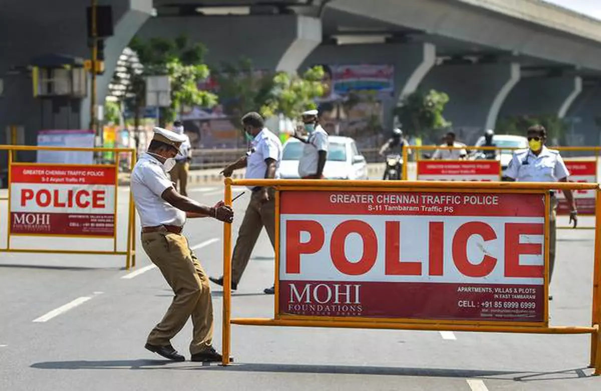 (File Photo) Traffic police personnel prepare to block a road near the airport when the 21-day total countrywide lockdown was announced  to contain the spread of Covid-19, in Chennai,  March 25, 2020. 
