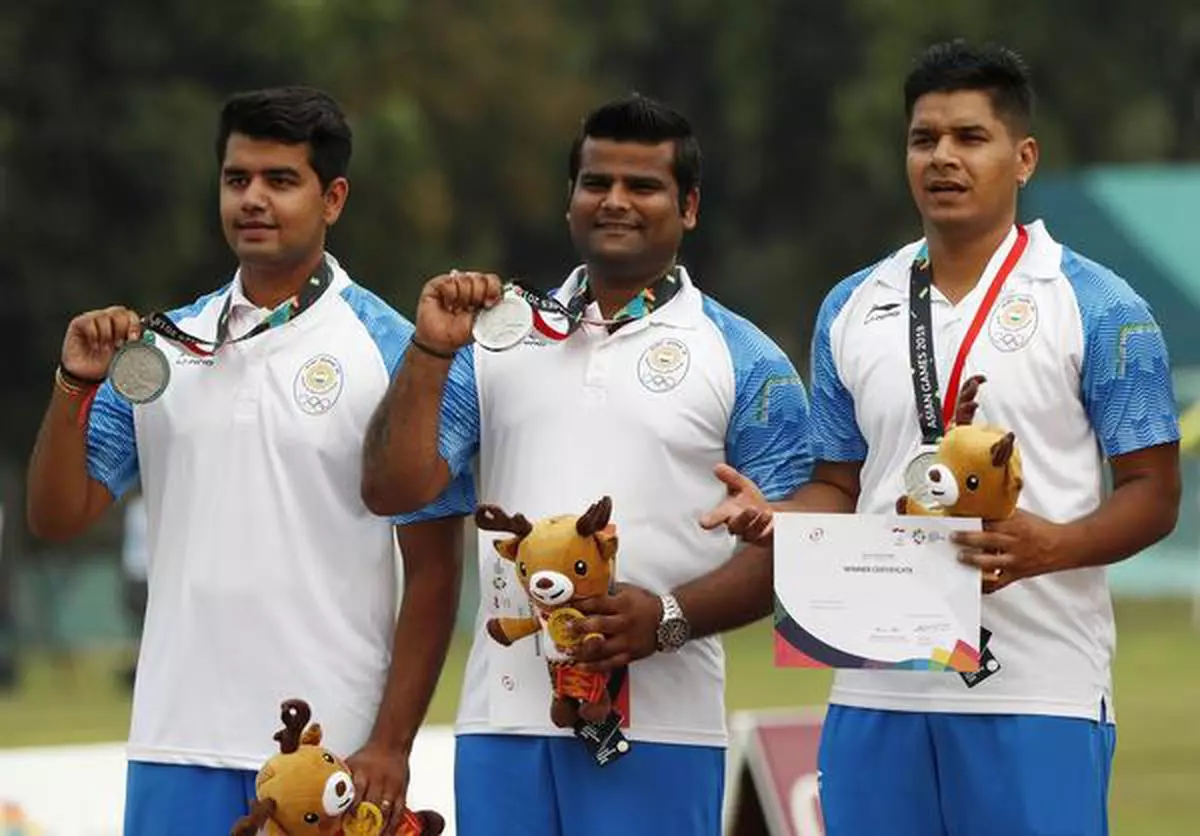  Archery: silver medallists Team India pose with their medals.
