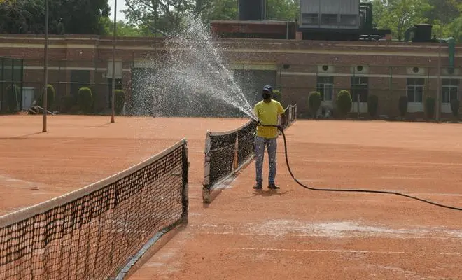 A worker has seen sprinkling water on the tennis court at the National Stadium in New Delhi on Thursday, July 08, 2021. (Photo: MOORTHY RV/The Hindu) A worker has seen sprinkling water on the tennis court at the National Stadium in New Delhi on Thursday, July 08, 2021. (Photo: MOORTHY RV/The Hindu)