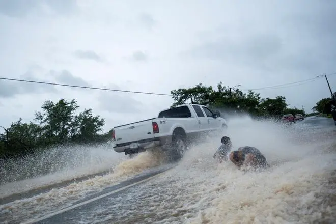 Children play in a flooded street in the aftermath of Hurricane Fiona in Salinas, Puerto Rico September 19, 2022. REUTERS Children play in a flooded street in the aftermath of Hurricane Fiona in Salinas, Puerto Rico September 19, 2022. REUTERS