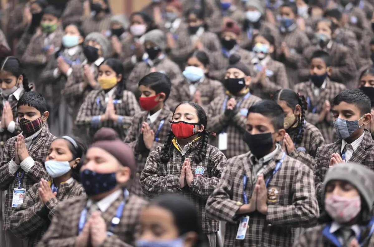 School students wearing face masks attend morning assembly at their school in Jammu, Friday, Dec 23, 2022. Precautions are being taken at schools amid sudden spurt in Covid cases in China and some other countries. (PTI Photo) 