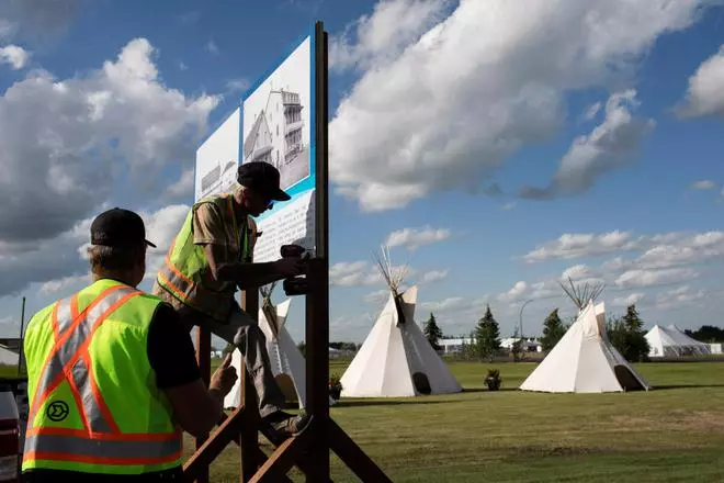 Workers prepare signage at the former site of the Ermineskin Residential School ahead of the visit of Pope Francis in Maskwacis, Alberta, Canada July 22, 2022. REUTERS