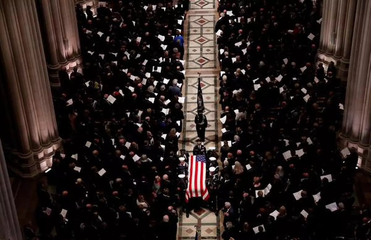 A military honor guard carries the flag-draped casket out of the cathedral at the conclusion of the state funeral for former President George HW Bush in the Washington National Cathedral in Washington, US, December 5, 2018. 
