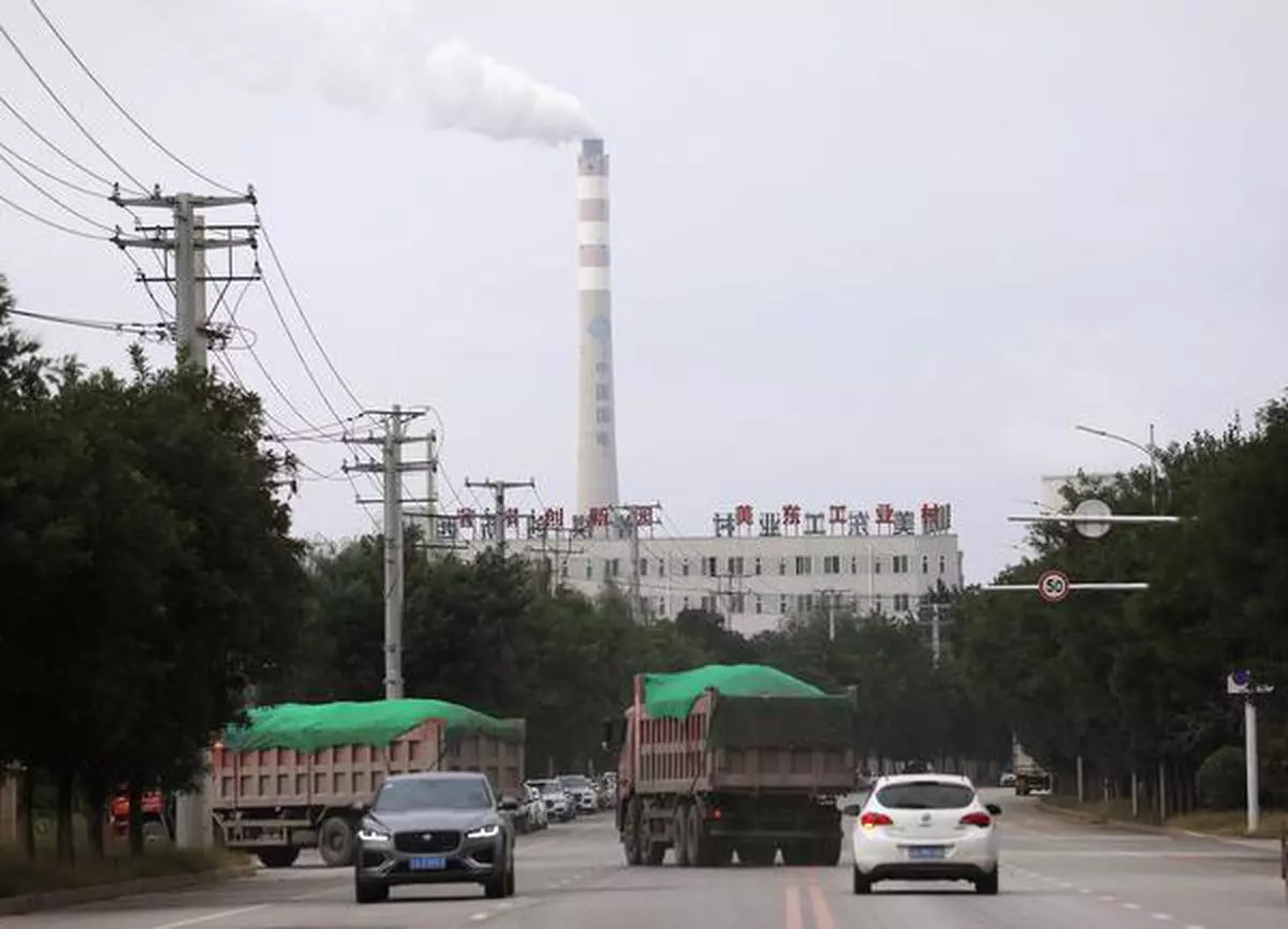 FILE PHOTO: A chimney of a China Energy coal-fired power plant is pictured in Shenyang, Liaoning province, China September 29, 2021. REUTERS/Tingshu Wang/File Photo
