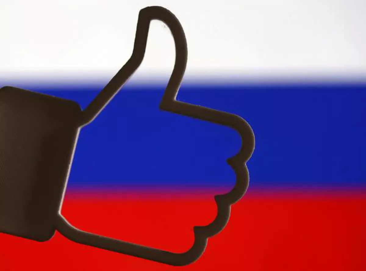 FILE PHOTO: A 3D-printed Facebook like button is seen in front of a displayed Russian flag in this illustration taken October 25, 2017. REUTERS/Dado Ruvic/Illustration/File Photo