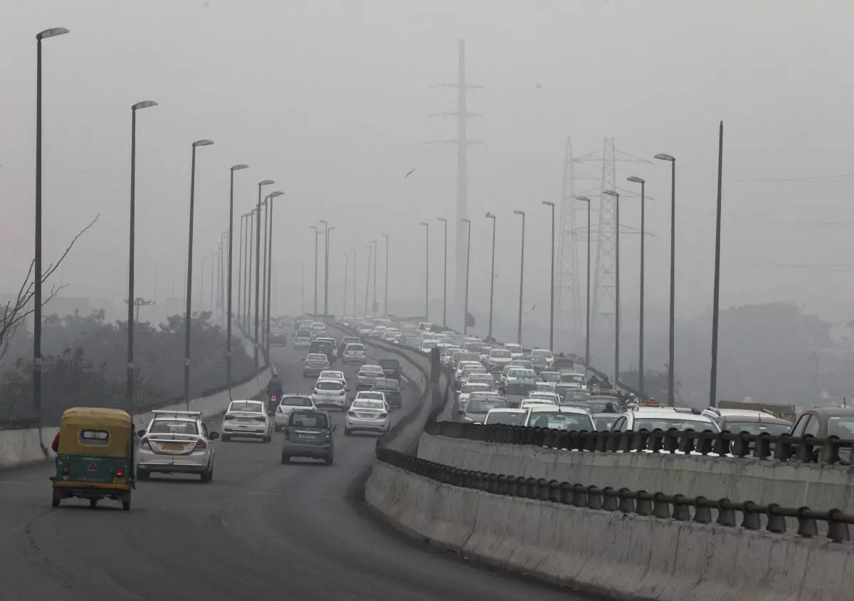 Vehicles are seen on a highway on a smoggy morning in New Delhi, India, December 2, 2021. REUTERS