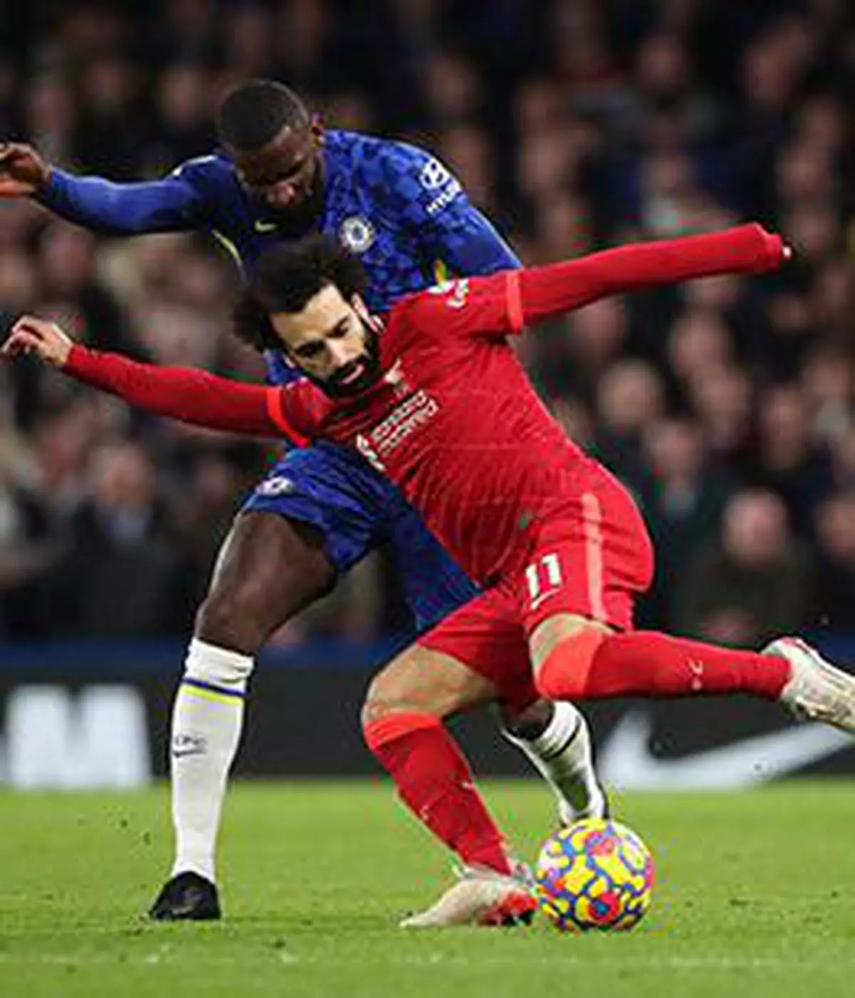 Soccer Football - Premier League - Chelsea v Liverpool - Stamford Bridge, London, Britain - January 2, 2022 Liverpool's Mohamed Salah in action with Chelsea's Antonio Rudiger Action Images via Reuters/Peter Cziborra EDITORIAL USE ONLY. No use with unauthorized audio, video, data, fixture lists, club/league logos or 'live' services. Online in-match use limited to 75 images, no video emulation. No use in betting, games or single club /league/player publications. Please contact your account representative for further details.