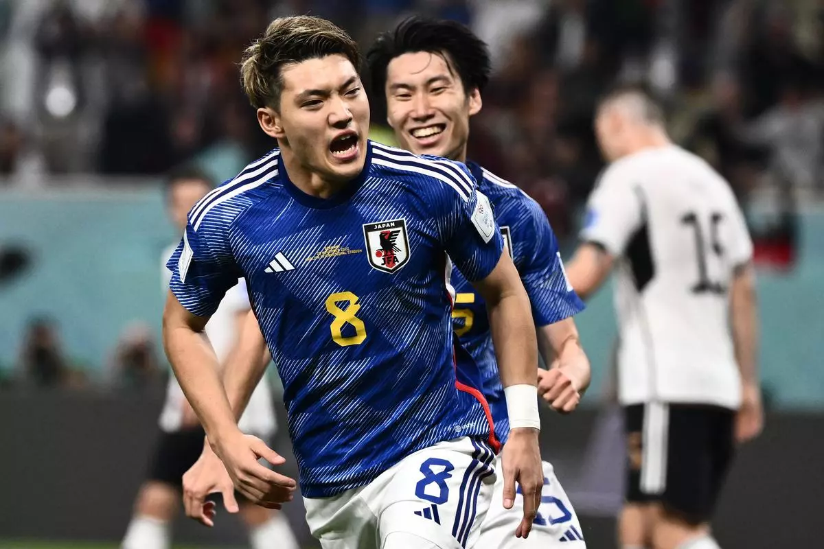 Japan’s midfielder #08 Ritsu Doan celebrates scoring his team’s first goal during the Qatar 2022 World Cup Group E football match between Germany and Japan at the Khalifa International Stadium in Doha on Wednesday