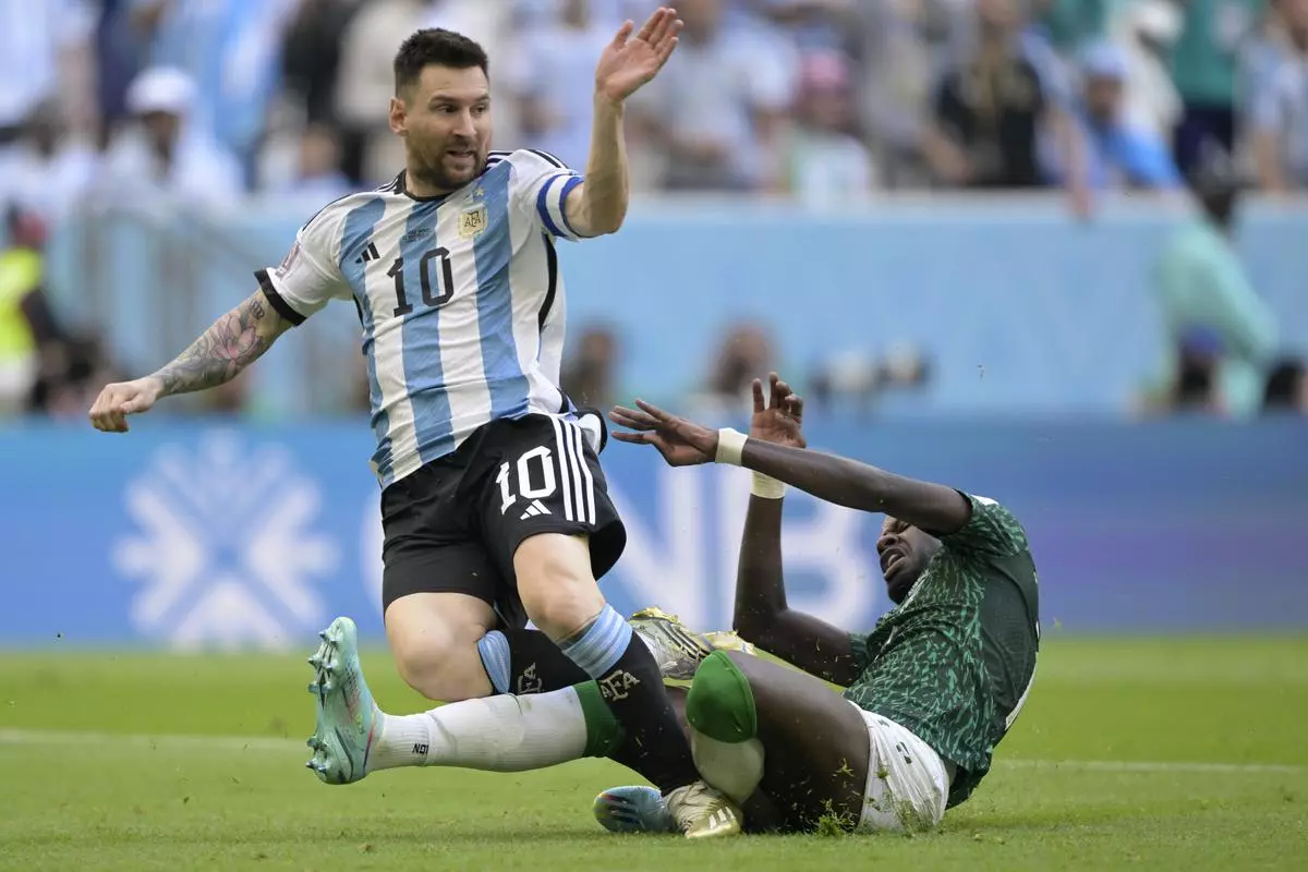 Argentina’s forward #10 Lionel Messi is tackled by Saudi Arabia’s defender #17 Hassan Altambakti during the Qatar 2022 World Cup Group C football match between Argentina and Saudi Arabia at the Lusail Stadium in Lusail, north of Doha on Tuesday.