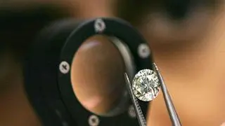 File picture: A diamond businessmen demonstrates a process at a diamond cutting and polishing factory in Surat.  Labour-intensive sectors like jewellery and apparel are the hardest hit by the high tariffs implemented by the US.